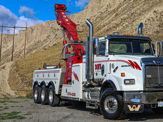 Don's heavy wrecker with its red boom raised high
