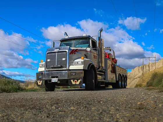 Low-angle front view of a Don's heavy wrecker under a blue sky