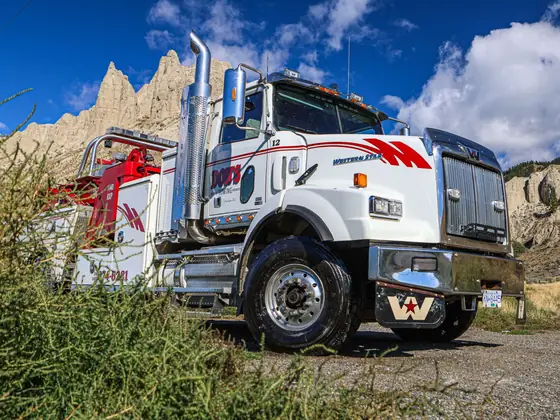 Don's heavy wrecker seen through roadside brush