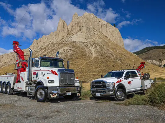 Don's heavy wrecker and light-duty wrecker parked below the hoodoos