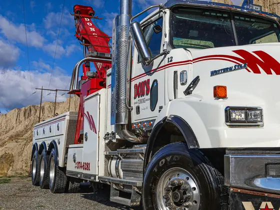 Close view of a Don's heavy wrecker's cab and chrome stacks