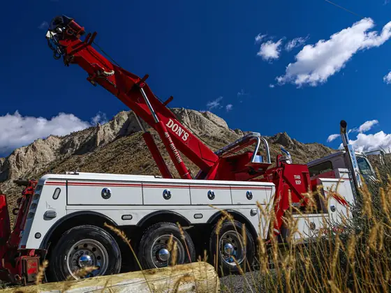 Don's heavy wrecker with its red boom raised