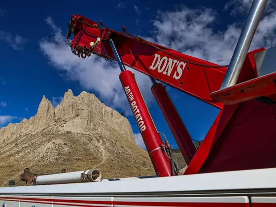 Close-up of a red DON'S boom against a sandstone peak