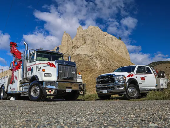 Don's heavy and light-duty wreckers side by side under a blue sky