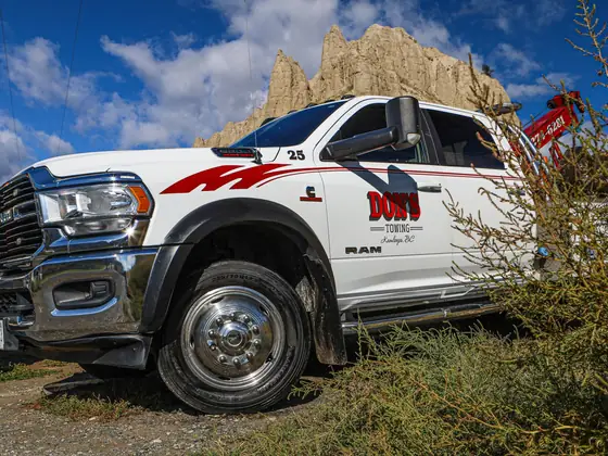 Don's Ram wrecker parked among roadside shrubs