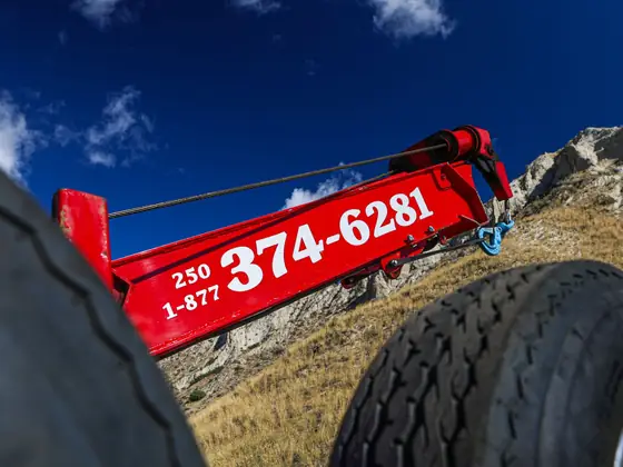Red wheel-lift boom showing Don's phone number, 250-374-6281