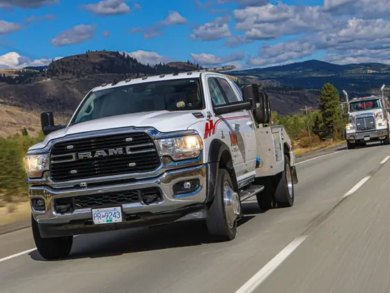Don's Ram wrecker leading a heavy wrecker down the highway