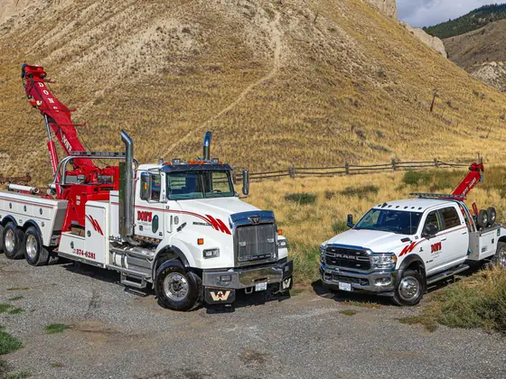 Don's heavy wrecker with its boom raised beside a light-duty wrecker