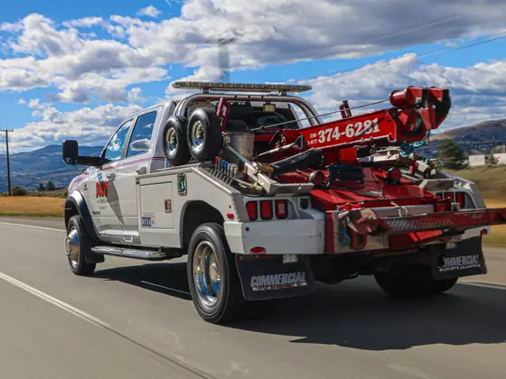 Don's Ram wheel-lift wrecker driving down the highway