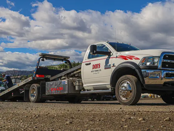 Don's flatbed with its deck tilted down, ready to load a car