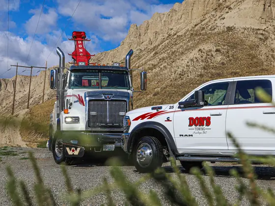 Don's heavy wrecker and Ram wrecker parked together in the grass